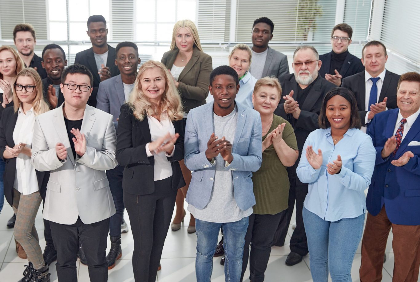 in full growth. group of diverse corporate employees applauding together . concept of teamwork.